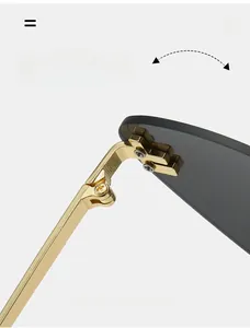 Macro view of durable gold metal hinge and grey lens on rimless cat eye sunglasses