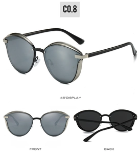 Multiple views of oversized round cat-eye sunglasses with silver metal frames and dark lenses