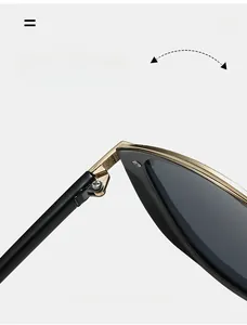 Detail of durable reinforced metal hinges on stylish black and gold sunglasses