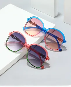 Detail view of square gradient sunglasses with transparent crystal frames on a white stand
