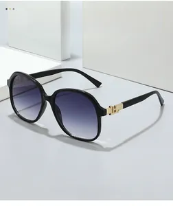 Detailed shot of large square sunglasses with purple gradient lenses and gold accents