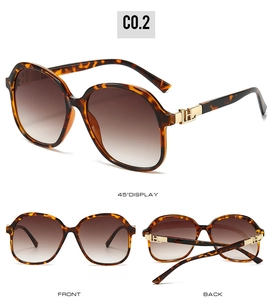 Detail of tortoiseshell square sunglasses with gold H-shaped metal hinge decoration