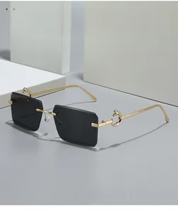 Detailed view of golden panther metal relief on frameless dark rectangular sunglasses