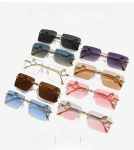 Flat lay of rimless rectangular sunglasses in nine colors with leopard metal hinges