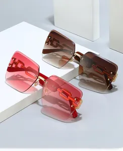 Detail view of rimless sunglasses with gold chain temples and gradient square lenses