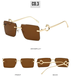 Detail view of rimless sunglasses with leopard metal hinge and tinted brown lenses