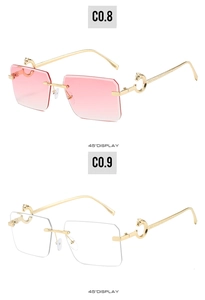 Detail view of rimless sunglasses featuring gold C-shape temple hinge and gradient lenses