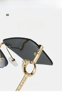 Detail of golden metal arm featuring a 3D leopard head on rimless sunglasses