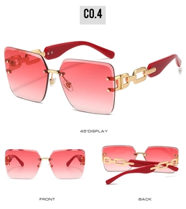 Detail view of rimless sunglasses with gold chain temples and red gradient lenses