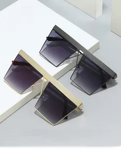 Detail view of square punk sunglasses with textured top frame and gradient purple lenses