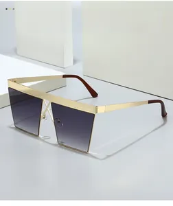Detail of square gold metal sunglasses frame with textured top bar and gradient lenses