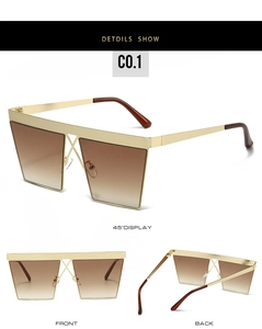 Detail of square gold metal sunglasses with brown gradient lenses and cross bridge