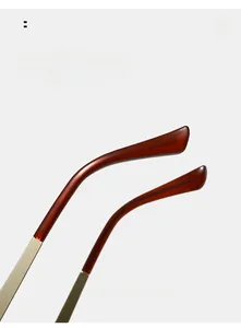 Detail of curved golden metal temples with tortoiseshell tips for eyewear comfort