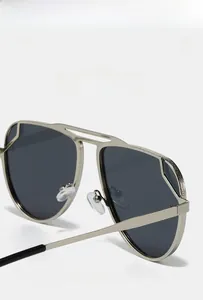 Detailed macro view of silver pilot sunglasses featuring textured metal frames and soft pads