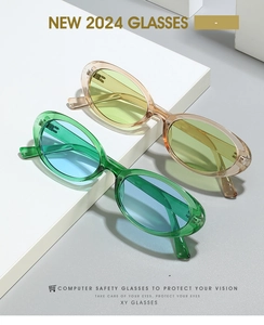 Detail of vintage oval eyewear with translucent green and champagne frames on props