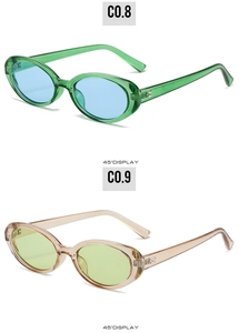 45-degree angle detail showing translucent green and pink oval frame retro sunglasses
