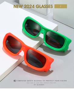 Detail of neon green and orange rectangular fashion sunglasses on white geometric blocks