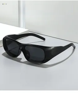 Detail of glossy black rectangular sunglasses with thick frames and sporty design