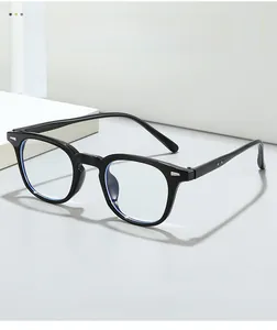 Detail view of black vintage square glasses frame with metallic rivets on a white podium