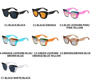 Detail view of seven trendy cat-eye sunglasses with gold logo and stylish leopard frames