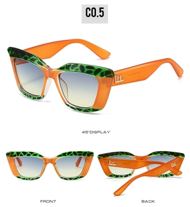 Chic cat-eye sunglasses with orange frames, green leopard patterns, and gradient lenses