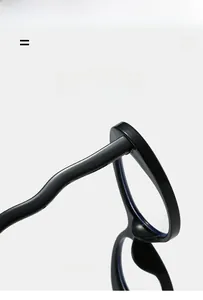Detail of wavy curved temples on glossy black oval frames showing super elastic material