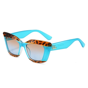 Fashionable sky blue cat-eye sunglasses with leopard print accents and gradient lenses