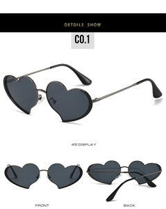 Détails macro de lunettes de soleil en forme de cœur avec monture en métal et verres sombres