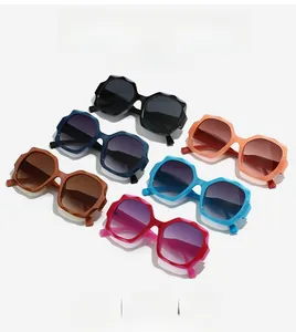 Detail view of colorful faceted geometric sunglasses with gradient lenses and resin frames