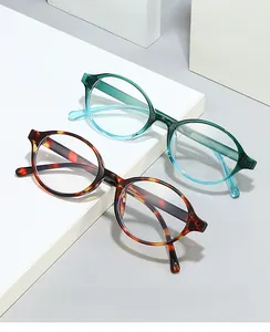 Detail of vintage oval anti-blue light glasses in gradient green and tortoiseshell finish