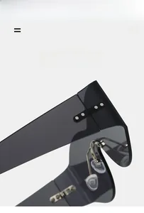 Detail view of translucent dark gray oversized sunglasses with silver rivet accents