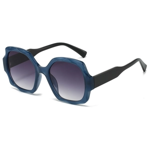 Modern square sunglasses with blue translucent frame and dark gray gradient lenses