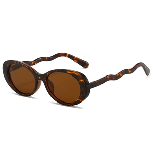 Vintage oval sunglasses with tortoiseshell frames and unique wavy temple design for women