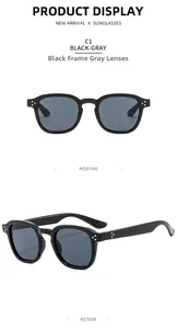 Close-up of classic retro square sunglasses in black with grey lenses and metal rivet detail