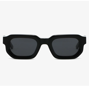 Front view of thick black acetate rectangular sunglasses with dark lenses on white background