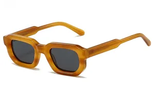Side view of retro chunky rectangular sunglasses with translucent amber frames and dark lenses