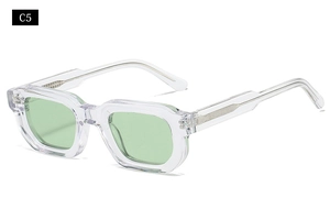 Close-up of thick transparent plastic square frame sunglasses with light green lenses