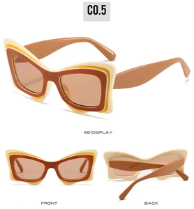 Détails de lunettes de soleil œil-de-chat avec monture superposée beige jaune et marron