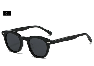 Detail of retro oval thick-frame sunglasses with silver metal studs and gray lenses