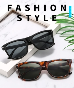 Detail of square oversized sunglasses in black and tortoiseshell with silver metal accents