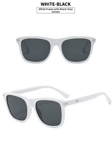 Detailed close-up of square white plastic frames with grey lenses and silver studs