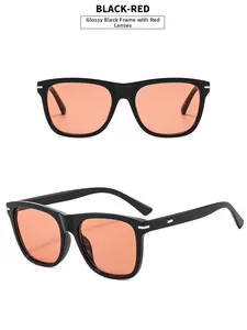 Detail view of rectangular black frame sunglasses with vibrant orange-red lenses