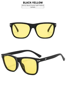 Detail of square black frame sunglasses with yellow lenses and silver metal hinges