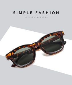Detailed close-up of retro tortoiseshell patterned frames on stylish oval sunglasses