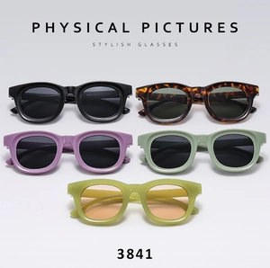 Flat lay of stylish oval thick frame sunglasses in multiple vibrant colors and finishes