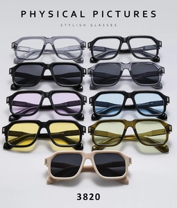Flat lay of retro square sunglasses in diverse colors with thick acetate frames