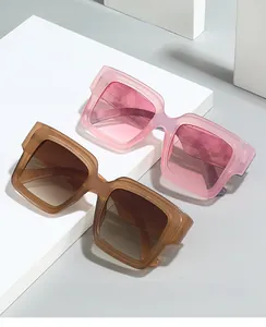 Close-up of stylish large square sunglasses in translucent pink and amber tea finishes