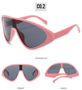 Detail view of pink oversized shield sunglasses with embossed FASHION text on the temples