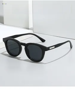 Detail of vintage oval sunglasses featuring silver metal stripe accents on black temples