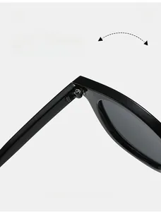 Macro shot of high-quality black oval sunglasses showing the durable metal hinge detail